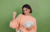Femme heureuse qui tient une liasse de billets
